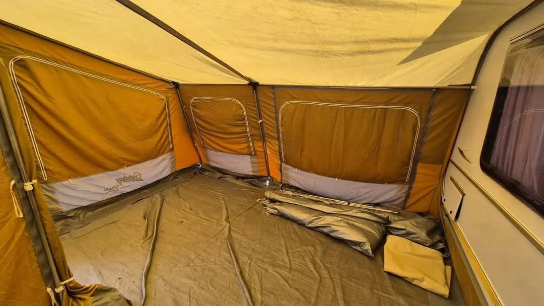 Camping tent pitched at sunset in the mountains