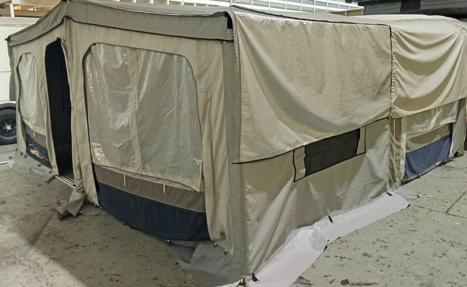 Camping tent repair sewing workshop with fabric and tools